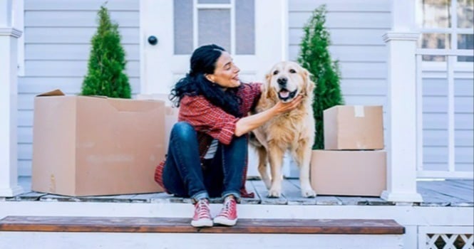 woman and dog on front porch moving to new home