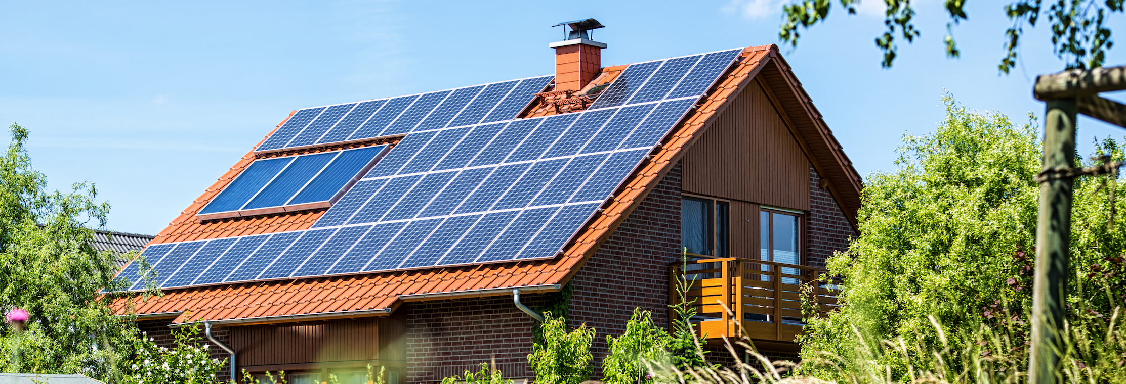Solar panels on house in green field
