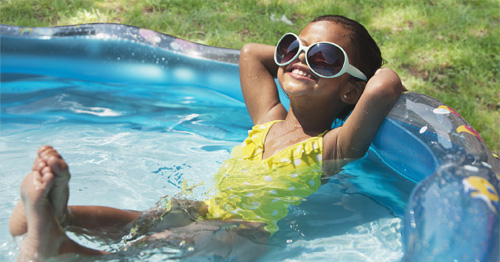Little girl relaxing in inflatable pool
