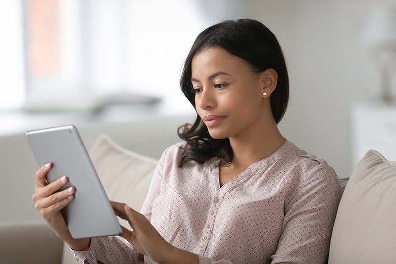 woman looking at tablet